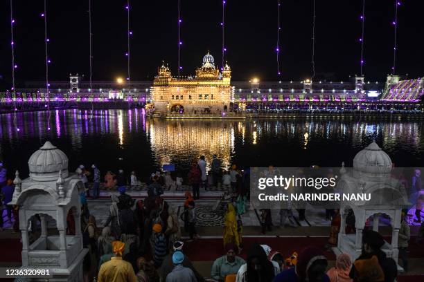 Sikh devotees pay their respect on the eve of Bandi Chhor Divas festival at the illuminated Golden Temple in Amritsar on November 3, 2021.