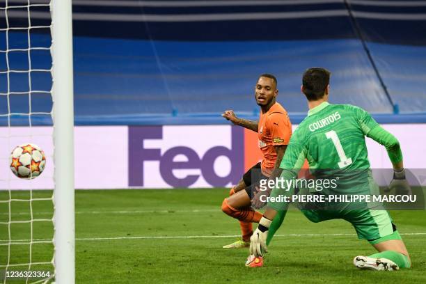 Shakhtar Donetsk's Brazilian forward Fernando Dos Santos Pedro shoots and scores a goal past Real Madrid's Belgian goalkeeper Thibaut Courtois during...