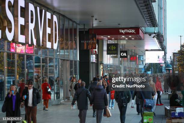 People are seen at a strip mall shopping center in Warsaw, Poland on 03 November, 2021.