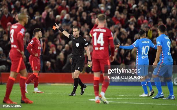 Referee Danny Makkelie sends off Atletico Madrid's Brazilian defender Felipe during the UEFA Champions League group B football match between...