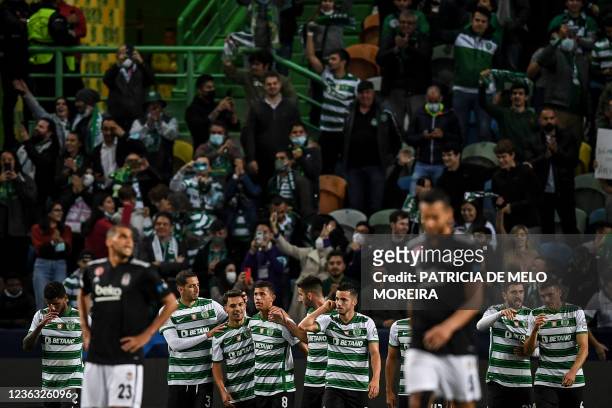 Sporting Lisbon's Portuguese midfielder Pedro Goncalves celebrates with teammates after scoring a goal during the UEFA Champions League first round...