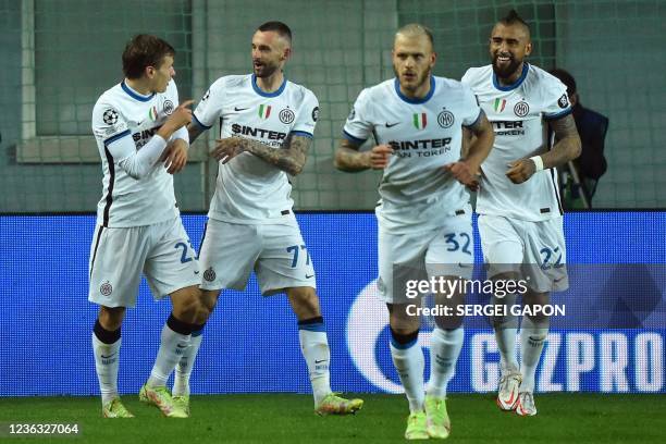 Inter Milan's Croatian midfielder Marcelo Brozovic celebrates with teammates after scoring the opening goal during the UEFA Champions League group D...