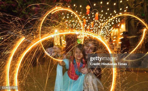 Family celebrates Diwali with firecrackers at Shivaji Park, Dadar on November 3, 2021 in Mumbai, India.