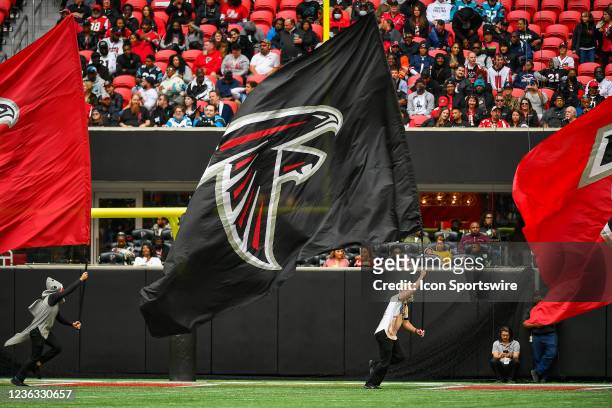 Atlanta cheerleaders run with a flag during the NFL game between the Carolina Panthers and the Atlanta Falcons on October 31st, 2021 at Mercedes-Benz...