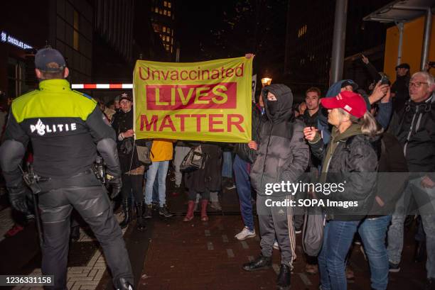 Protesters holding a banner saying, unvaccinated lives matter, during the demonstration.The police arrested thirteen people during an anti-corona...