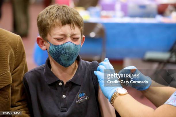 Nathaniel Garris of Pasadena, receives a childs dose of the Pfizer vaccination from LVN Jacqueline Valdez, at Eugene A. Obregon Park on Wednesday,...