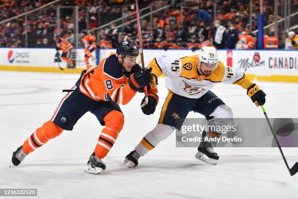 Kyle Turris of the Edmonton Oilers battles for the puck against Alexandre Carrier of the Nashville Predators on November 3, 2021 at Rogers Place in...