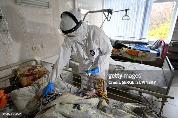 Medical personnel provides medical assistance to a Covid-19 patient inside the intensive care unit in an hospital which treats patients with COVID-19...