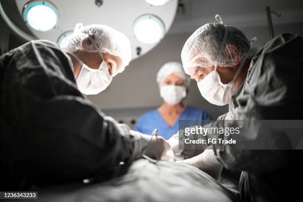 Doctors doing a surgery on operating room in hospital