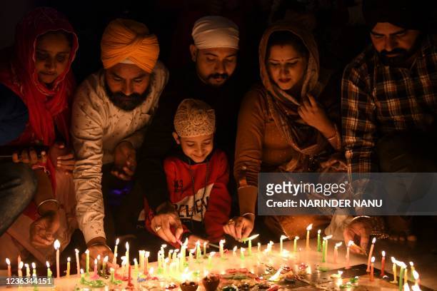 Sikh devotees light candles on the occasion of Bandi Chhor Divas, a Sikh festival coinciding with Diwali, the Hindu festival of light, at the...