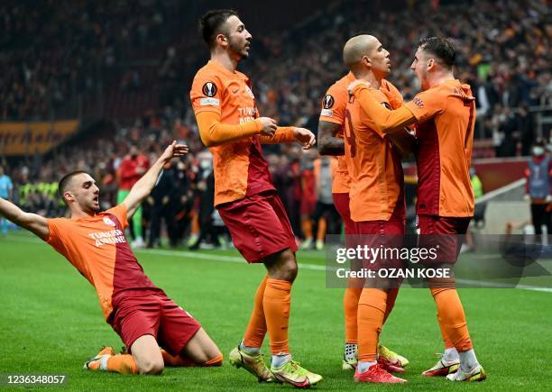 Galatasaray's Algerian midfielder Sofiane Feghouli celebrates with teammates after scoring during the UEFA Europa League group E football match...