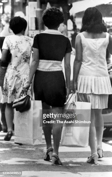 Women wearing miniskirts walk on the street on August 29, 1968 in Tokyo, Japan.