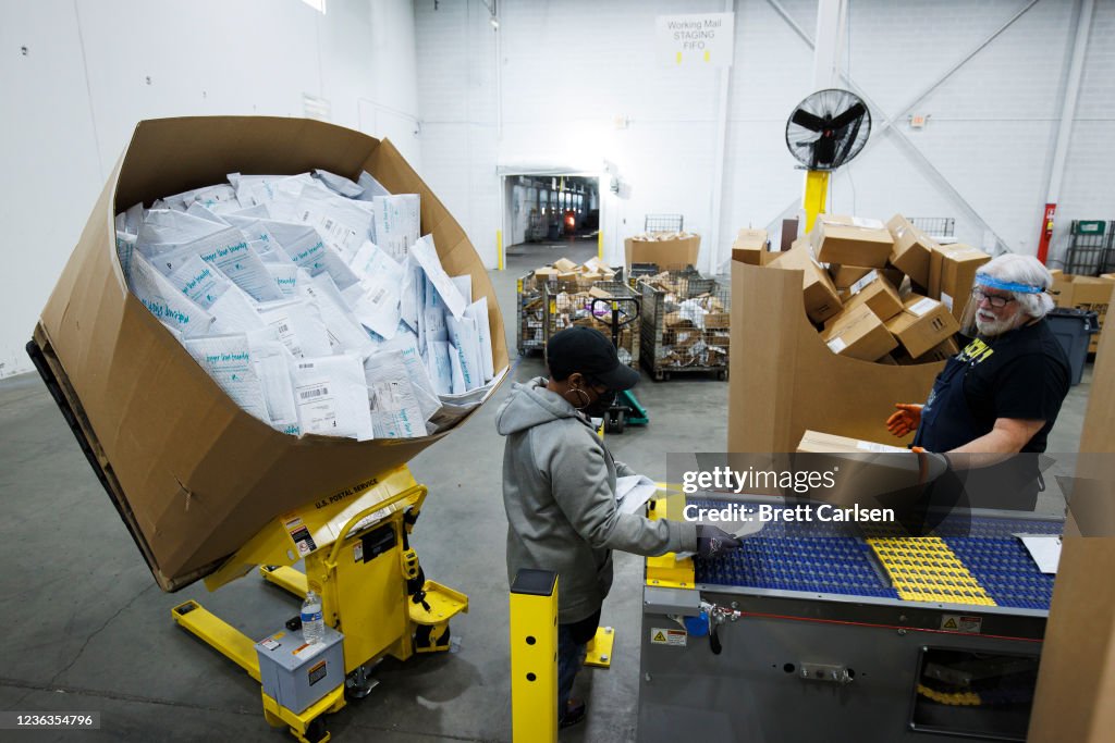 Usps Mail Load Workers load mail onto a Single Induction Parcel Sorter which sorts ...