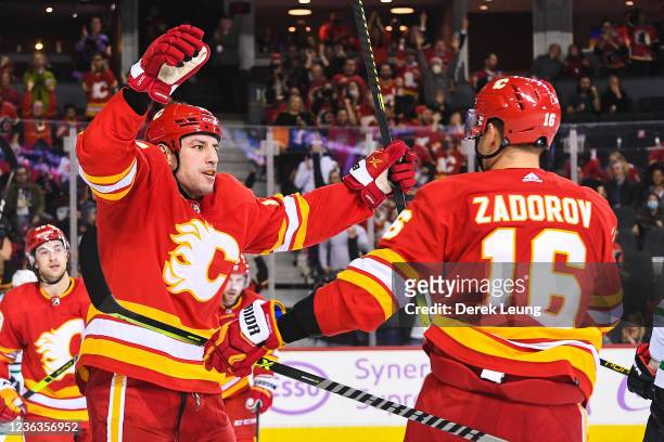 Milan Lucic celebrates with Nikita Zadorov of the Calgary Flames after Lucic scored against the Dallas Stars during an NHL game at Scotiabank...