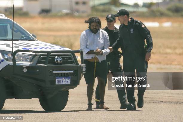 Terence Darrell Kelly boards a plane after being taken into custody by members of the Special Operations Group at Carnarvon airport on November 5,...