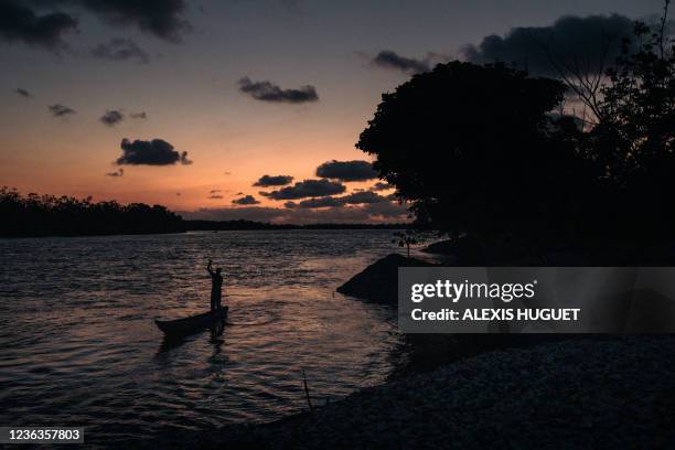 A fisherman of Nteva village gets back home at dusk in the Mangrove Marine Park at the mouth of the Congo River, in the extreme southwest of the...