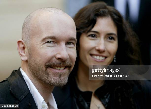 Guitar player for the rock group U2, The Edge smiles flanked by his wife Morleigh Steinberg after attendin the wedding of famous Italian tenor...