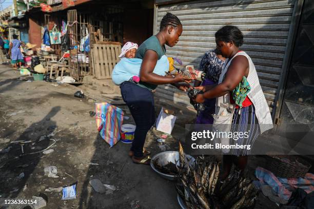 Vendor serves a customer at a food market in Accra, Republic of Ghana, on Wednesday, Nov. 3, 2021. Ghanas inflation rate breached the central banks...