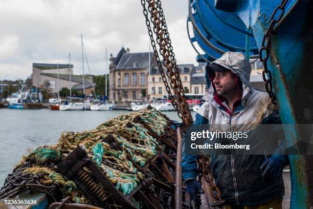 Deck hand checks on blades and nets for scallop fishing and dredging aboard a French trawler in Dieppe, France, on Thursday, Nov. 4, 2021. Tensions...