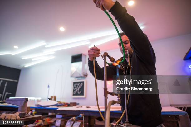 Glass tube is heated and bent into shape at Endeavour Neon in Langley, British Columbia, Canada, on Wednesday, Nov. 3, 2021. Neon lights have been...