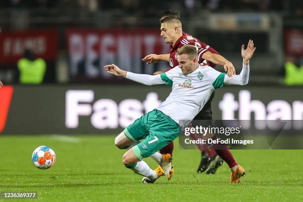 Marvin Ducksch of SV Werder Bremen and Nikola Dovedan of 1. FC Nuernberg battle for the ball during the Second Bundesliga match between 1. FC...