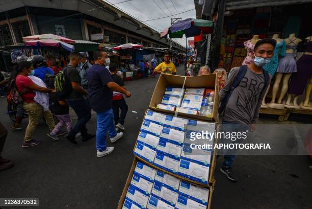 Man sells protective masks in the historic center on November 5, 2021 in San Salvador, El Salvador. Continuing with Coronavirus pandemic restrictions...