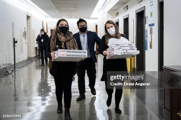 Staff members carry boxes of pizza to a meeting of the House Progressive Caucus on Capitol Hill November 05, 2021 in Washington, DC. After months of...