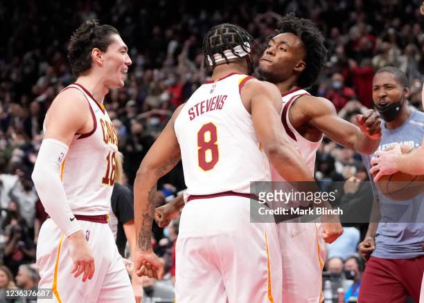 Collin Sexton, Lamar Stevens, and Cedi Osman of the Cleveland Cavaliers celebrate defeating the Toronto Raptors in their basketball game at the...