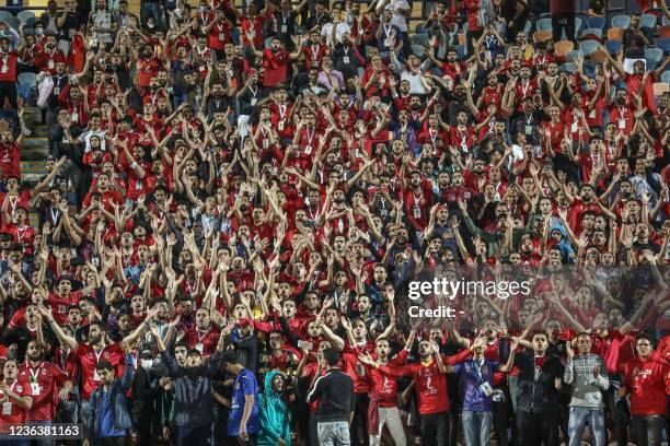 Egypt's al-Ahly fans attend a football match with al-Zamalek in the Egyptian Premier League at the Cairo International Stadium in the capital on...