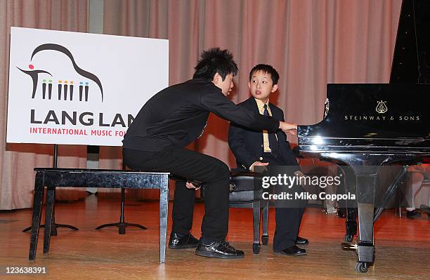 Pianist Lang Lang and US Young Scholar Charlie Liu perform at PS 334 - The Anderson School on January 3, 2011 in New York City.