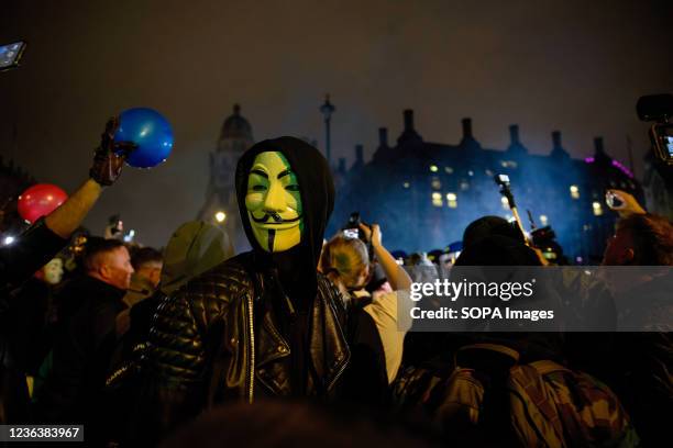 Protester is seen wearing a Guy Fawkes mask during the protest. Protesters gathered at Trafalgar square for the annual Million Mask March. The annual...