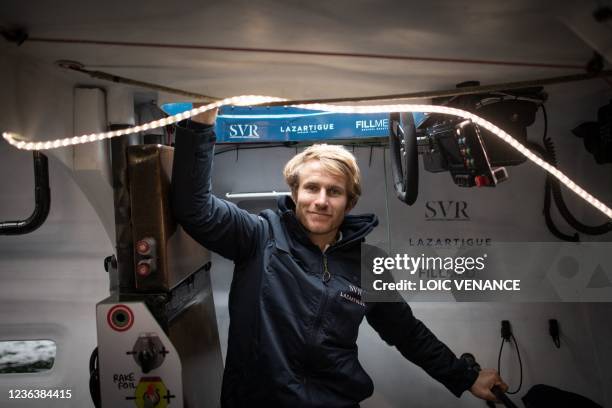 French skipper Francois Gabart poses aboard the Ultim multihull SVR - Lazartigue at the harbour of Le Havre, northern France, on November 6 a day...