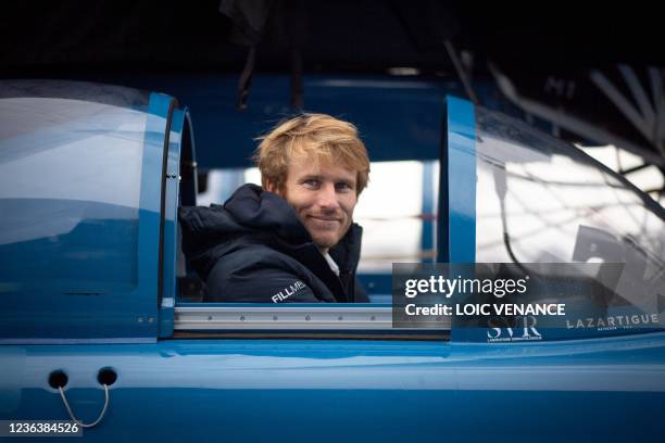 French skipper Francois Gabart poses aboard the Ultim multihull SVR - Lazartigue at the harbour of Le Havre, northern France, on November 6 a day...