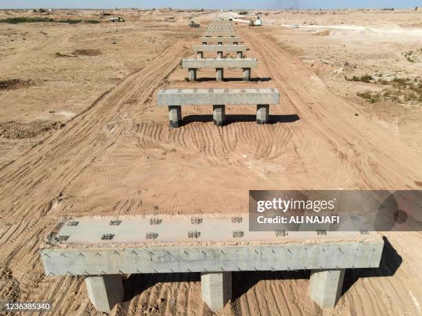 This aerial view shows cement structures built as part of a land road project in the central Iraqi Najaf governorate, that will link Najaf to Saudi...