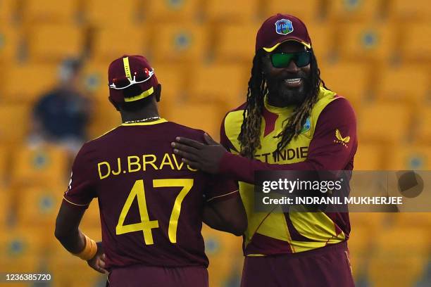 West Indies' Chris Gayle greets his teammate Dwayne Bravo at the end of the ICC mens Twenty20 World Cup cricket match between Australia and West...