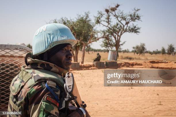 Senegalese Blue Helmet peacekeeper stands next to United Nations armoured vehicle in the village of Ogossagou, Mopti Region on November 5, 2021. -...