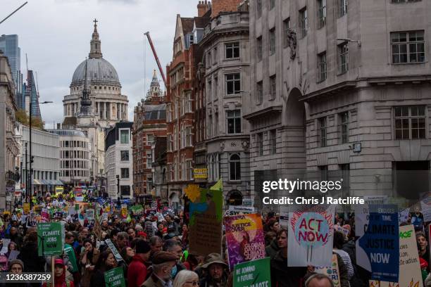 Protesters march along Fleet Street during a global day of action on climate change on November 6, 2021 in London, United Kingdom. Protest groups...
