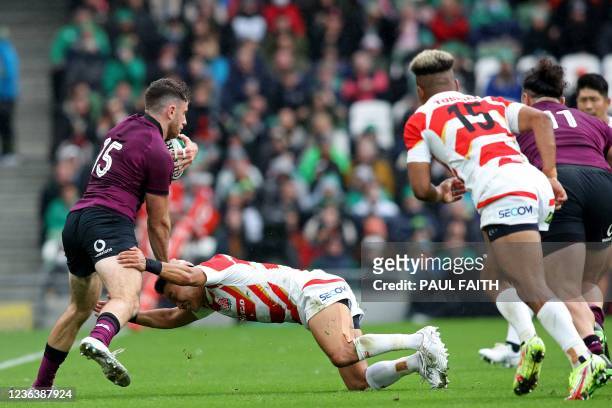 Ireland's full-back Hugo Keenan is tackled by Japan's Naoto Saito during the Autumn International friendly rugby union match between Ireland and...