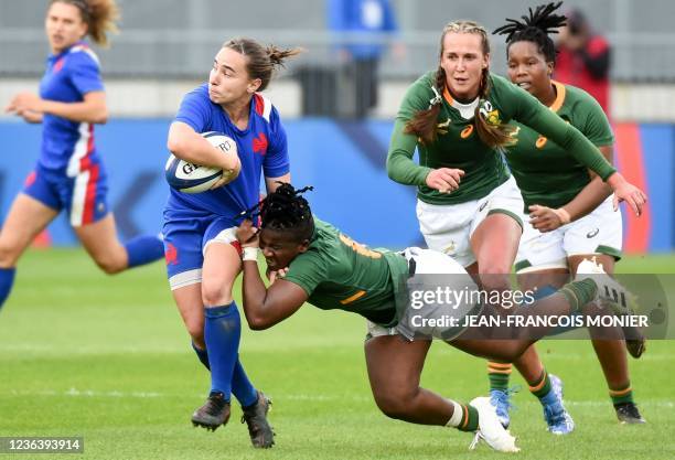 France's scrum-half Laure Sansus is tackled by South-Africa's flanker Lusanda Dumke during the women's international rugby test match between France...