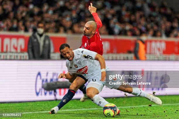 Burak Yilmaz of Lille OSC competes for the ball with Enzo Ebosse of Angers SCO during the Ligue 1 match between Lille and Angers on November 6, 2021...