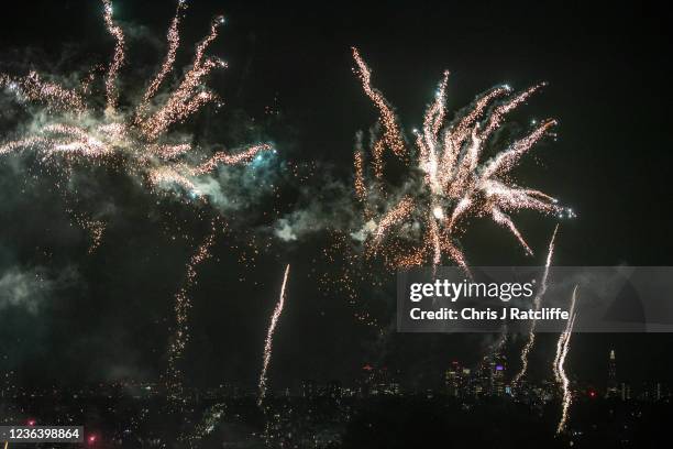 Crowds watch a firework display as part of bonfire night celebrations at Alexandra Palace with a view of the city of London in the distance on...