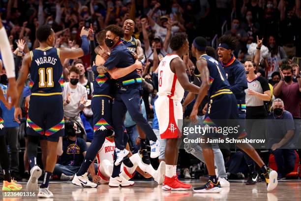 The Denver Nuggets celebrate after a last second blocked shot by Nikola Jokic seals the win against the Houston Rockets at Ball Arena on November 6,...
