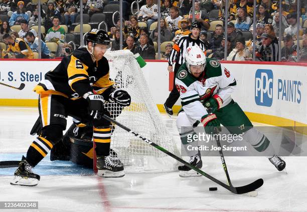 Frederick Gaudreau of the Minnesota Wild handles the puck against Mike Matheson of the Pittsburgh Penguins at PPG PAINTS Arena on November 6, 2021 in...