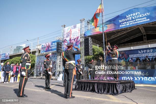 Members of a military music band raise a flag during a rally in Addis Ababa, Ethiopia, on November 7 in support of the national defense forces. -...