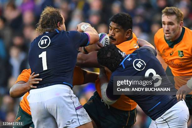Australia's Will Skelton is tackled by Scotland's prop Pierre Schoeman and Scotland's prop Zander Fagerson during the Autumn International rugby...