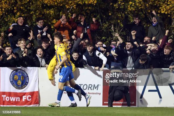 Shrewsbury Town fans falls over the advertising boards as he celebrates during the Emirates FA Cup First Round match between Stratford Town and...