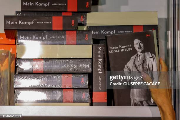 Woman reaches for a copy of Adolf Hitler's book "Mein Kampf" at the Sharjah International Book Fair in the Gulf emirate of Sharjah, on November 7,...