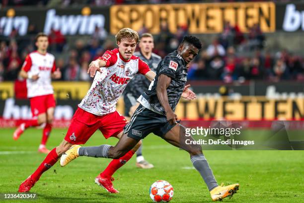 Timo Bernd Huebers of FC Koeln and Taiwo Awoniyi of 1. FC Union Berlin battle for the Ball during the Bundesliga match between 1. FC Köln and 1. FC...