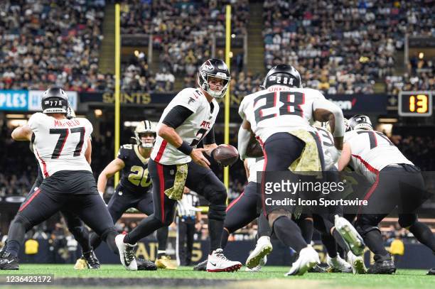 Atlanta Falcons quarterback Matt Ryan hands off to Atlanta Falcons running back Mike Davis near his own endzone during the football game between the...