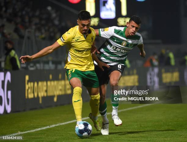 Pacos de Ferreira's Portuguese defender Jorge Silva fights for the ball with Sporting Lisbon's Brazilian midfielder Matheus Nunes during the...